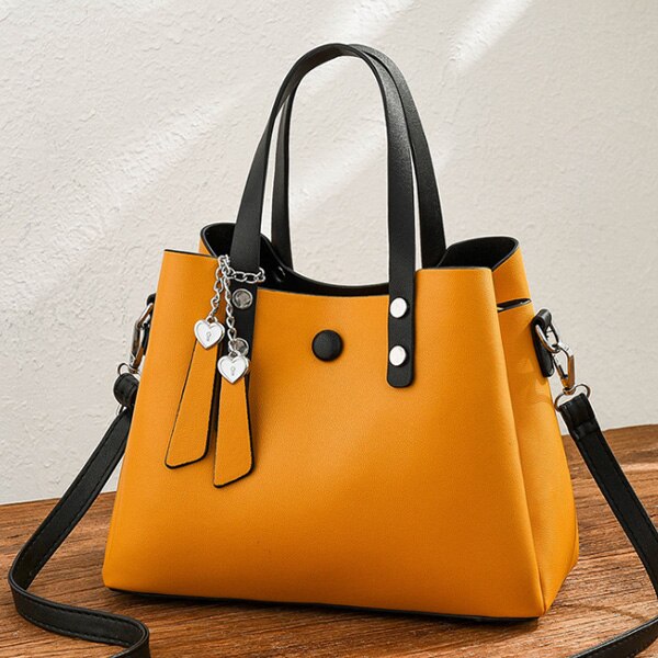 HEART TASSEL DETAILED YELLOW HANDBAG