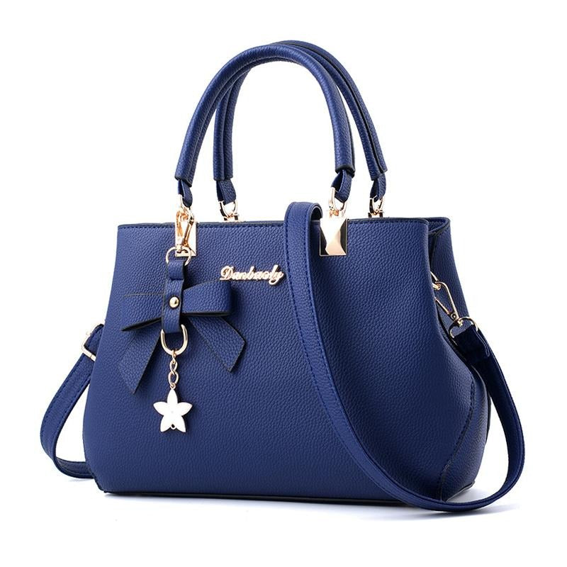 BOW AND FLOWER TASSEL DETAILED BLUE HANDBAG